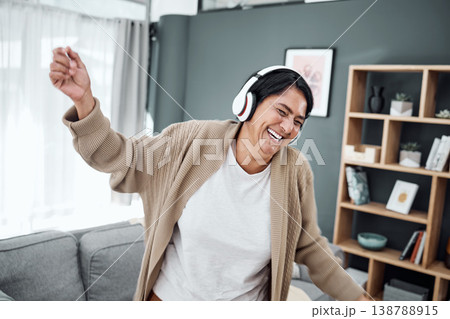 Senior, dance or happy woman streaming music or laughing to relax with freedom in home living room. Retirement, headphones or excited senior person listening to radio song or audio with joy or smile Senior, dance or happy woman streaming music or laughing to relax with freedom in home living room. Retirement, headphones or excited senior person listening to radio song or audio with joy or smile 138788915