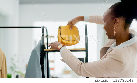 Fashion, bag and a black woman designer in a retail store as a small business owner or startup entrepreneur. Smile, accessories and a happy young employee in a shop at the mall for boutique sales Fashion, bag and a black woman designer in a retail store as a small business owner or startup entrepreneur. Smile, accessories and a happy young employee in a shop at the mall for boutique sales 138789145