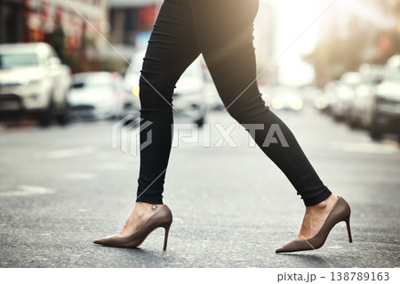 High heels, business and woman crossing the street closeup in a city on her commute to work. Feet, fashion and a female employee walking on an asphalt road in an urban town for a professional career High heels, business and woman crossing the street closeup in a city on her commute to work. Feet, fashion and a female employee walking on an asphalt road in an urban town for a professional career 138789163