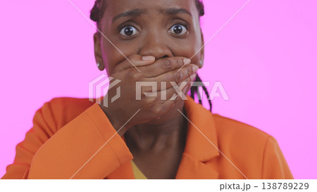 Black woman, hand over mouth with shock or surprise, drama or secret news with gossip isolated on pink background. Wow reaction for info, expression in portrait and alarm with fear in a studio Black woman, hand over mouth with shock or surprise, drama or secret news with gossip isolated on pink background. Wow reaction for info, expression in portrait and alarm with fear in a studio 138789229