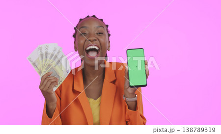 Woman, phone green screen and money for success, bonus or winning of lottery or competition, profit and wow in studio. African winner, portrait and mobile mockup for cash prize on a pink background 138789319