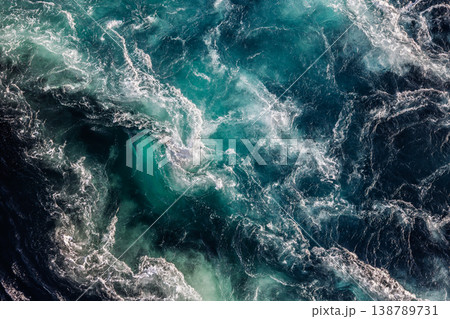 Blue waves of water of the river and the sea meet each other during high tide and low tide. 138789731