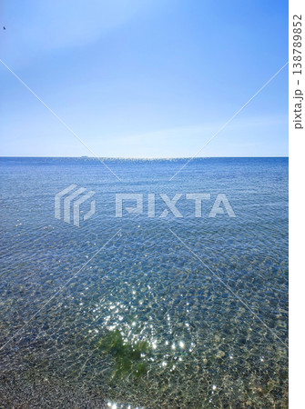 Seascape. Sea Smooth surface of the blue sea and blue sky. Abstract sea view scenery. Sea landscape. Skyline. Nature backdrop. Natural background. Nobody. Sun glare. Calm sunny weather. Small waves Seascape. Sea Smooth surface of the blue sea and blue sky. Abstract sea view scenery. Sea landscape. Skyline. Nature backdrop. Natural background. Nobody. Sun glare. Calm sunny weather. Small waves 138789852
