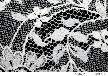Close up of vintage lace fabric white on black background embroidery 138789954