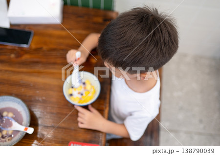 Young Boy Enjoying Dessert in a Cozy Cafe Setting 138790039