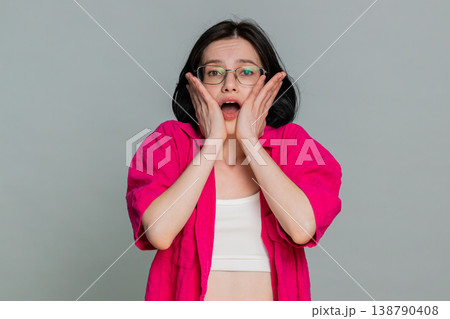 Woman shivering looking around anxiously hugging shoulders expressing fear worry nervous feeling Woman shivering looking around anxiously hugging shoulders expressing fear worry nervous feeling 138790408