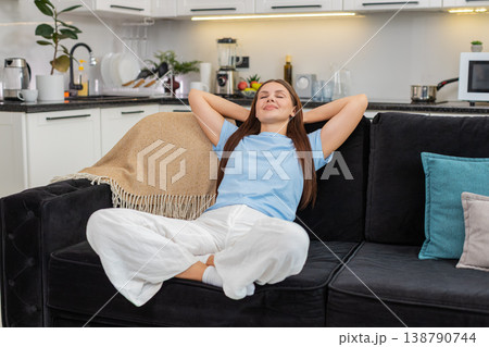 Young woman leans back smiles with hands behind head relaxed chill posture easy rest calm and happy Young woman leans back smiles with hands behind head relaxed chill posture easy rest calm and happy 138790744