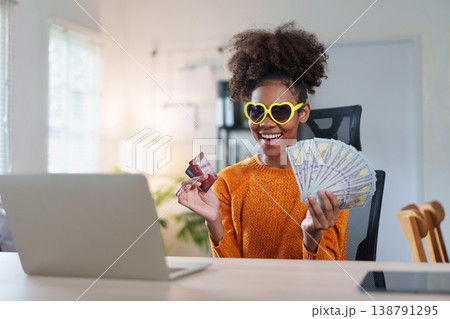 Smiling African American Woman Holding Cash and Credit Cards. Smiling African American Woman Holding Cash and Credit Cards. 138791295