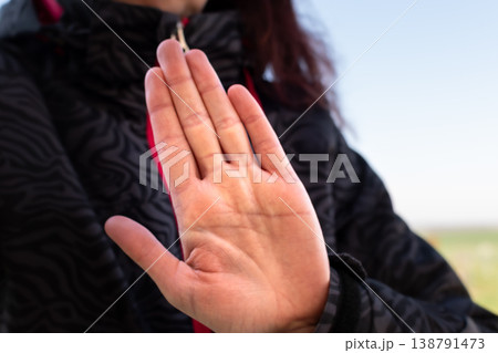 Woman making gesture with her hand outdoors Woman making gesture with her hand outdoors 138791473