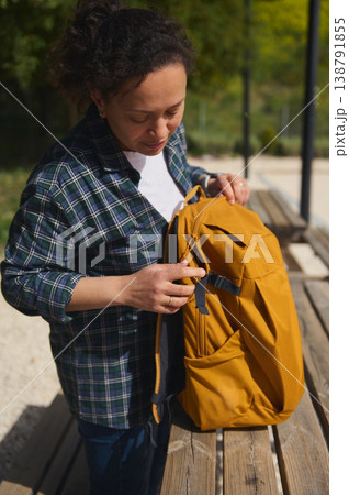 Woman standing with backpack after outdoor remote work 138791855
