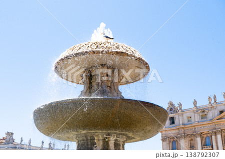 Fountain in the Vatican. Seagull bird bathes and drinks water in summer. Blue sky Fountain in the Vatican. Seagull bird bathes and drinks water in summer. Blue sky 138792307
