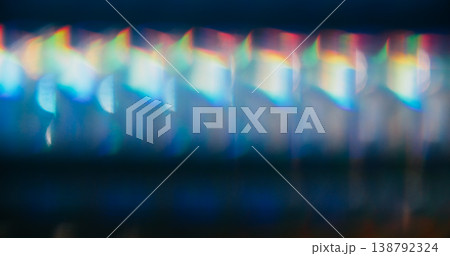 Film defocused glow. Neon luminosity. Colorful mixing blue white orange reflection. Optical lens on art black abstract background. Film defocused glow. Neon luminosity. Colorful mixing blue white orange reflection. Optical lens on art black abstract background. 138792324