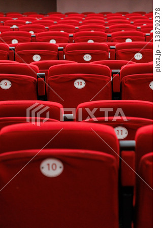 auditorium of cinema or theater. Empty rows of red velvet armchairs filling auditorium. 138792378