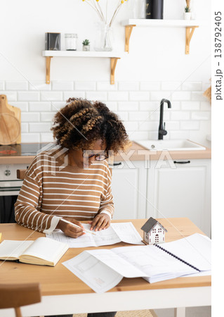 female architect designer is working, taking notes in notebook is mock up of house on table. female architect designer is working, taking notes in notebook is mock up of house on table. 138792405
