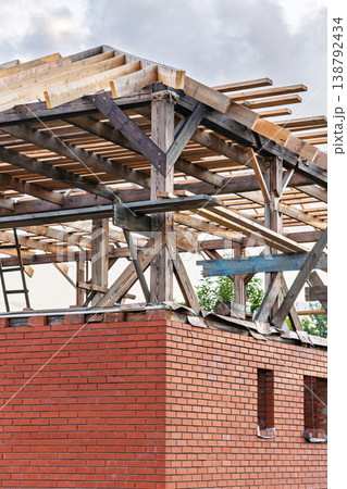 Old wood beams show signs. Aging timber above bricks emphasizes texture and possible reuse Old wood beams show signs. Aging timber above bricks emphasizes texture and possible reuse 138792434