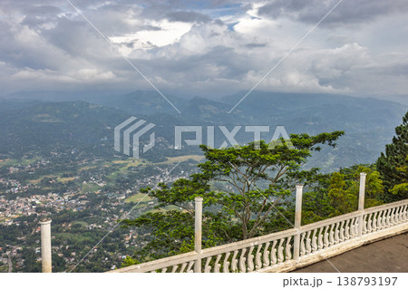 View from Ambuluwawa Tower, multi-religious temple complex located in Gampola, in Sri Lanka. Panoramic Mountain Vista with Lush Green Landscape and Distant Urban Settlements View from Ambuluwawa Tower, multi-religious temple complex located in Gampola, in Sri Lanka. Panoramic Mountain Vista with Lush Green Landscape and Distant Urban Settlements 138793197