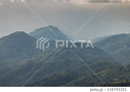 View from Ambuluwawa Tower, multi-religious temple complex located in Gampola, in Sri Lanka. Verdant Mountain Landscape with Hazy Skies and Lush Forests View from Ambuluwawa Tower, multi-religious temple complex located in Gampola, in Sri Lanka. Verdant Mountain Landscape with Hazy Skies and Lush Forests 138793201