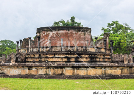 Ancient Royal Palace Ruins in Polonnaruwa, Sri Lanka. Ancient circular temple ruin with weathered masonry and stone architecture, surrounded by lush green grass and tropical trees Ancient Royal Palace Ruins in Polonnaruwa, Sri Lanka. Ancient circular temple ruin with weathered masonry and stone architecture, surrounded by lush green grass and tropical trees 138793210