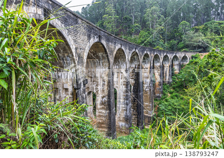 Nine Arch Bridge near Ella town in Sri Lanka. Historic Stone Arch Bridge Amidst Lush Green Tropical Forest Scenery, Architectural Marvel in a Verdant Landscape Nine Arch Bridge near Ella town in Sri Lanka. Historic Stone Arch Bridge Amidst Lush Green Tropical Forest Scenery, Architectural Marvel in a Verdant Landscape 138793247