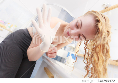 Woman with white latex gloves in bathroom Woman with white latex gloves in bathroom 138793472
