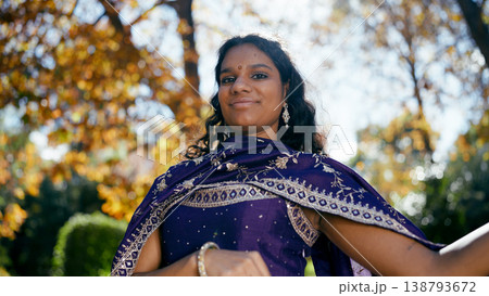 Indian woman smiling, wearing traditional dress outdoors 138793672