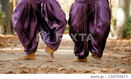 Indian women practicing yoga outdoors in autumn Indian women practicing yoga outdoors in autumn 138793673