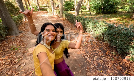 Indian women friends dancing enjoying autumn park outdoors Indian women friends dancing enjoying autumn park outdoors 138793918