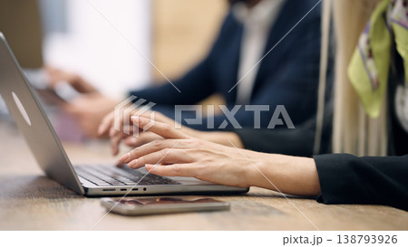 Woman typing on laptop keyboard in office Woman typing on laptop keyboard in office 138793926