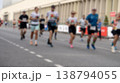 Blurred runners sprint down a city street 138794055