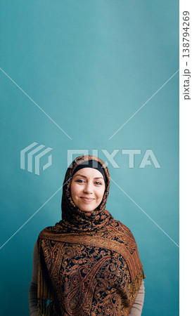 Muslim woman wearing paisley hijab smiling at camera Muslim woman wearing paisley hijab smiling at camera 138794269