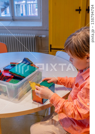 Child Learning with Colorful Building Blocks and Magnetic Tiles.  138794784