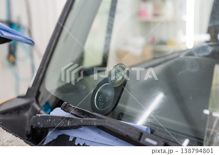 Repairing a chip on a car windshield. Repairing a chip on a car windshield. 138794801