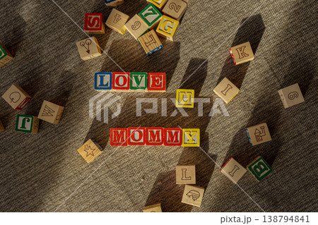 Colorful childrens wooden blocks making words love you mommy.  138794841
