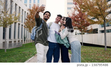 Students taking selfie outdoors on campus 138795486