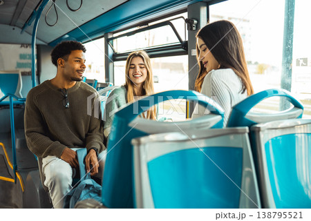 Diverse young adults enjoying friendly bus commute 138795521