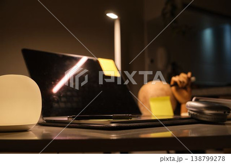 Home office desk showing laptop during night study Home office desk showing laptop during night study 138799278