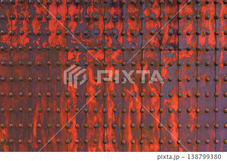 Himeji, Japan - Sep 24 2024, a close-up view of metal surface consisting of iron sheets with many rivets, partially covered with red paint and rust, aged, part of gate of Himeji Castle, Himeji, Japan 138799380