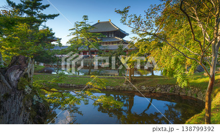 Nara, Japan - Sep 26 2024, Panoramic view across the pond and trees to the facade of Todaiji Temple, Great Buddha Hall, with a blue cloudy sky, Nara, Japan 138799392
