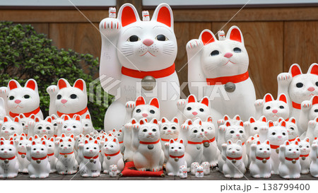 Tokyo, Japan - Sep 30 2024, A close-up view of many multi-sized white beckoning cat figure of Maneki neko with red ears and noses displayed at Gotokuji Temple, without people, at daytime, Tokyo, Japan Tokyo, Japan - Sep 30 2024, A close-up view of many multi-sized white beckoning cat figure of Maneki neko with red ears and noses displayed at Gotokuji Temple, without people, at daytime, Tokyo, Japan 138799400