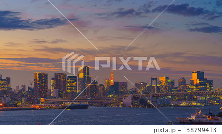 Tokyo, Japan - Oct 2 2024, Panoramic cityscape of Tokyo with Tokyo TV Tower and the Rainbow Bridge among buildings and skyscrapers, ships sailing in bay in foreground, at sunset, Tokyo, Japan 138799413
