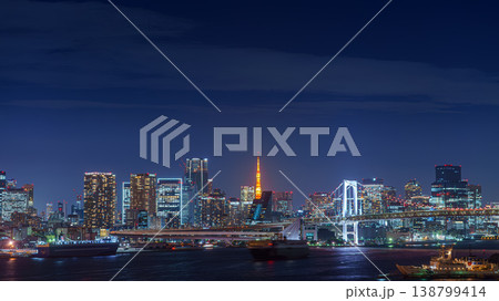 Tokyo, Japan - Oct 2 2024, panoramic aerial view of Tokyo Bay cityscape with skyscrapers in background and the Rainbow Bridge, at nighttime with illumination, Tokyo, Japan Tokyo, Japan - Oct 2 2024, panoramic aerial view of Tokyo Bay cityscape with skyscrapers in background and the Rainbow Bridge, at nighttime with illumination, Tokyo, Japan 138799414