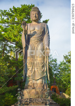 Sakata, Yamagata, japan - Oct 5 2024, A vertical view of the giant Great Buddha statue at Jichi-In Temple, with trees in the background, at daytime, Sakata, Japan Sakata, Yamagata, japan - Oct 5 2024, A vertical view of the giant Great Buddha statue at Jichi-In Temple, with trees in the background, at daytime, Sakata, Japan 138799423
