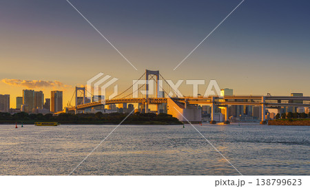 Tokyo, Japan - Oct 13 2024, panoramic view of Tokyo Bay with a cable-stayed Rainbow Bridge above it, a boat and a water bus sailing, at sunset, Tokyo, Japan Tokyo, Japan - Oct 13 2024, panoramic view of Tokyo Bay with a cable-stayed Rainbow Bridge above it, a boat and a water bus sailing, at sunset, Tokyo, Japan 138799623