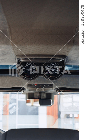 Dashboard view showing gauges and controls in a car interior in bright light 138800478
