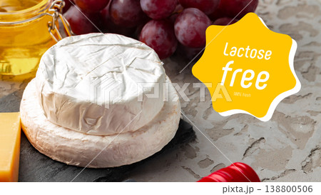 Cheese and grapes on a table with a label stating lactose free and gluten free 138800506