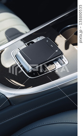 Close view of a car's center console with controls and a touchpad at night 138800535