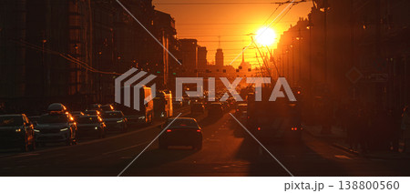 Saint-Petersburg, Russia - April 10 2026, panoramic view of Nevsky Prospect, cars on road, people walking on sidewalk, at sunset with bright sun, everything in orange light, St Petersburg, Russia 138800560