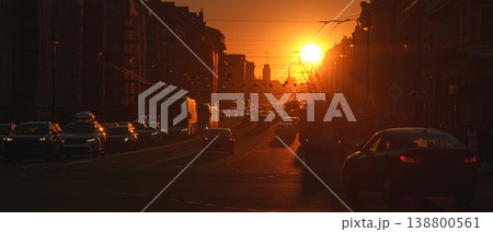 Saint-Petersburg, Russia - April 10 2026, panoramic view of Nevsky Prospect, cars on road, people walking on sidewalk, at sunset with bright sun, everything in orange light, St Petersburg, Russia 138800561