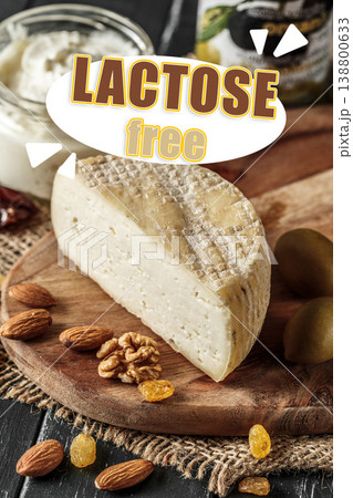 Cheese on wooden board with nuts and grapes, showcasing lactose free options for diet 138800633