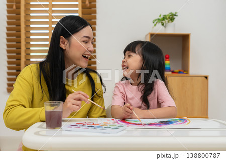 happy mother and preschool child girl painting on paper with watercolor in pan 138800787